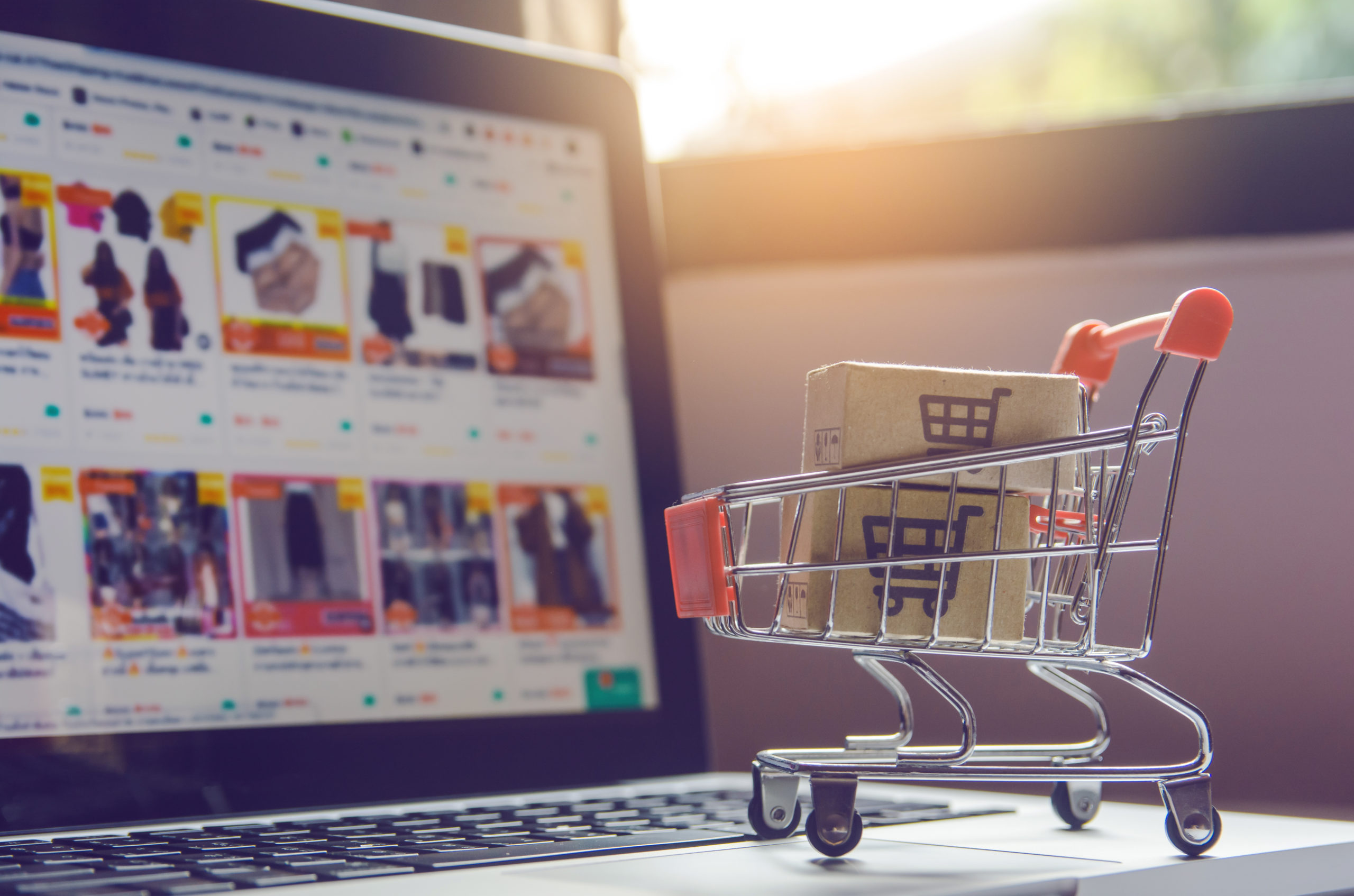 Shopping online concept – Parcel or Paper cartons with a shoppin